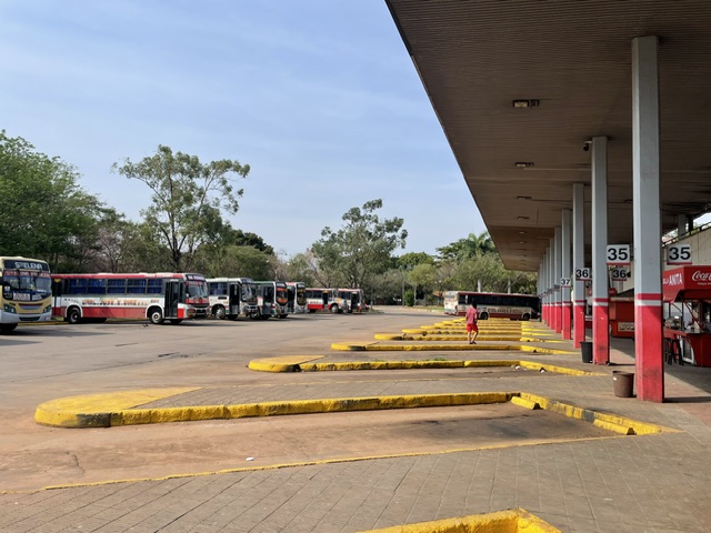 Numbered boarding bays and buses at Asunción bus station in September 2025