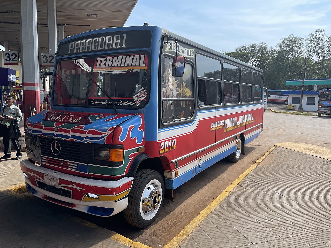A blue, red and white intercity bus at Asunción bus station in September 2025