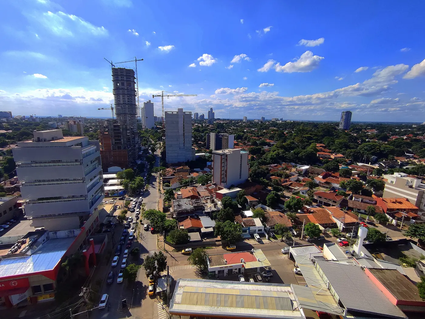 Traffic on Avenida Molas López seen from above, with houses and tall buildings behind
