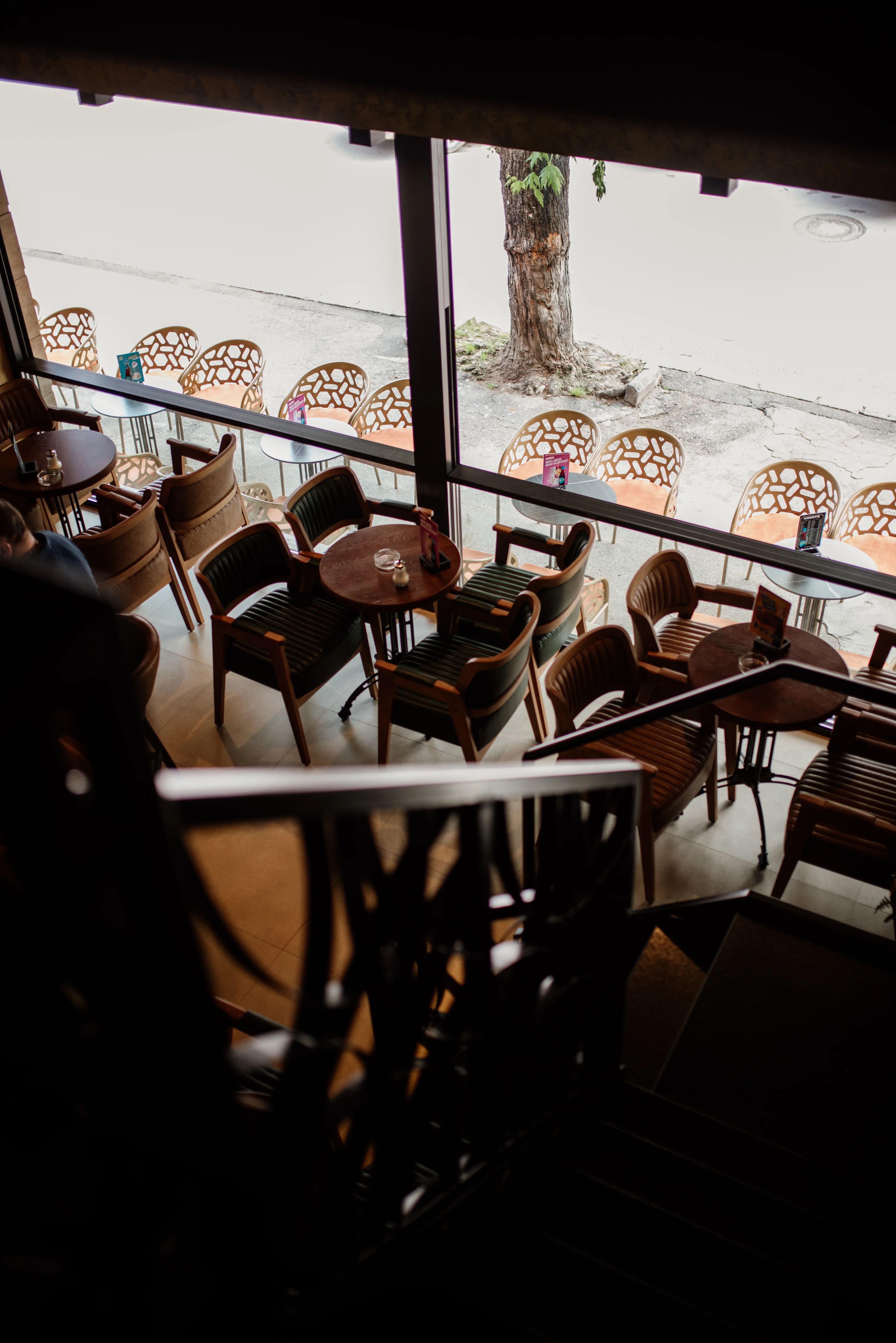 A café interior with stylish seating and large windows