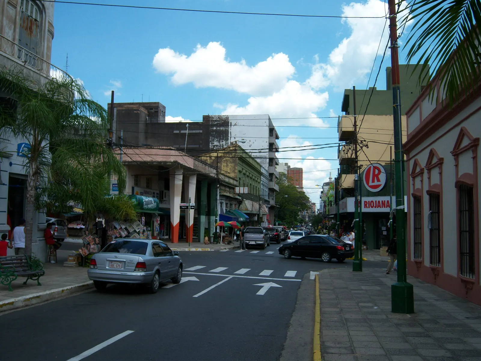 Calle Palma lined with palm trees and low historic buildings under a blue sky