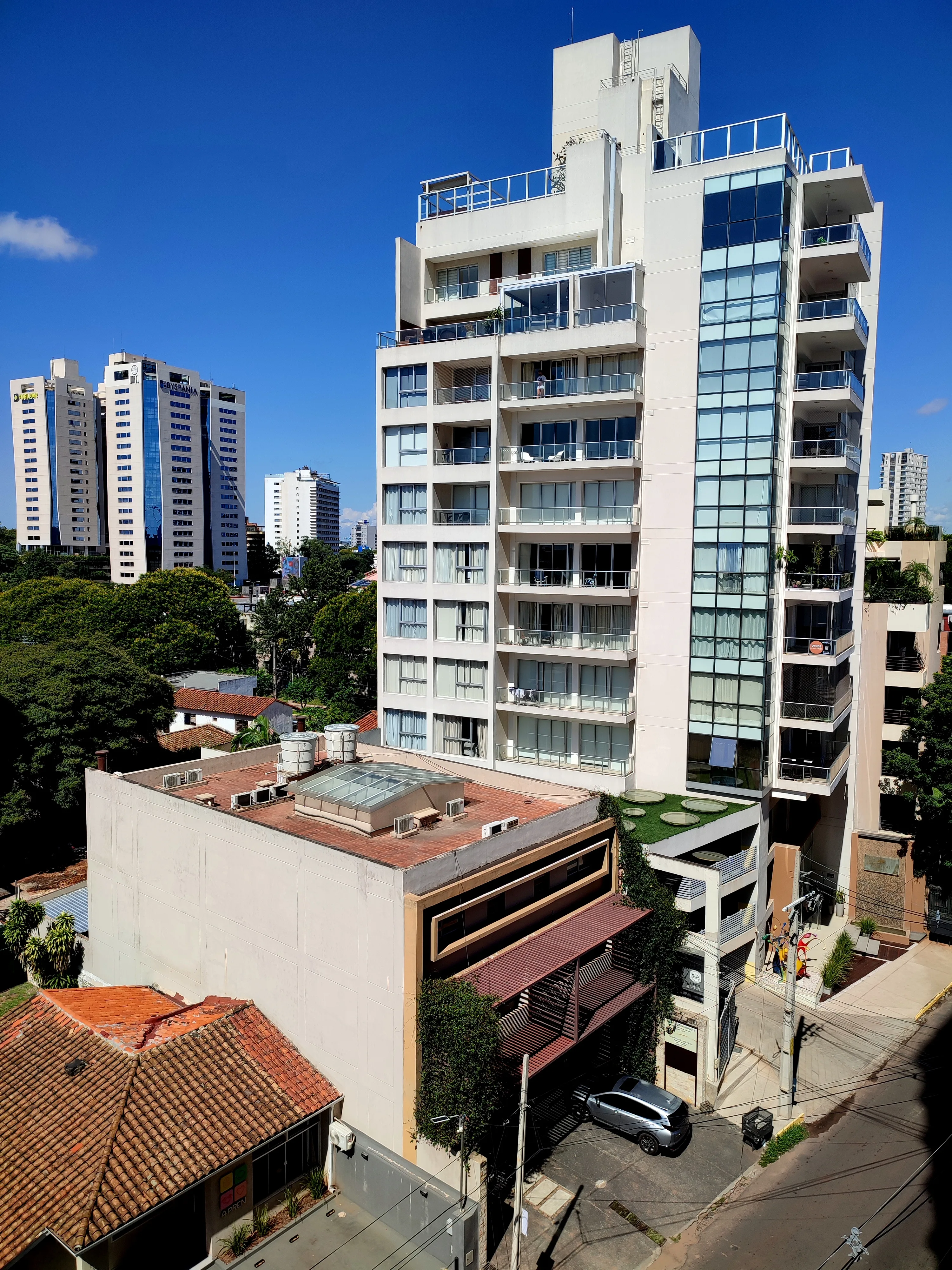 Modern residential tower with glass facade and balconies in Las Lomas, Asunción
