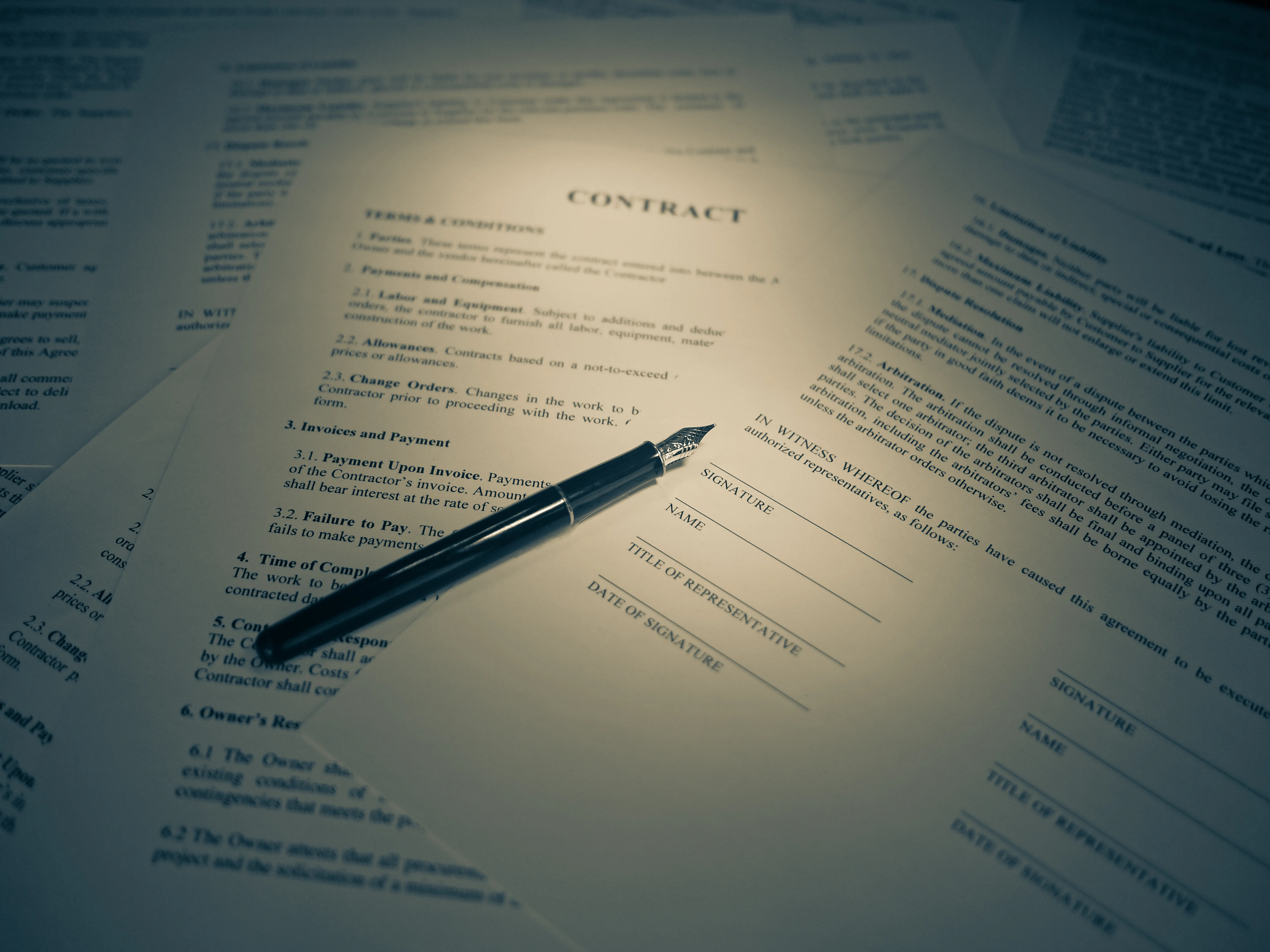 Signed contract documents with a fountain pen on top