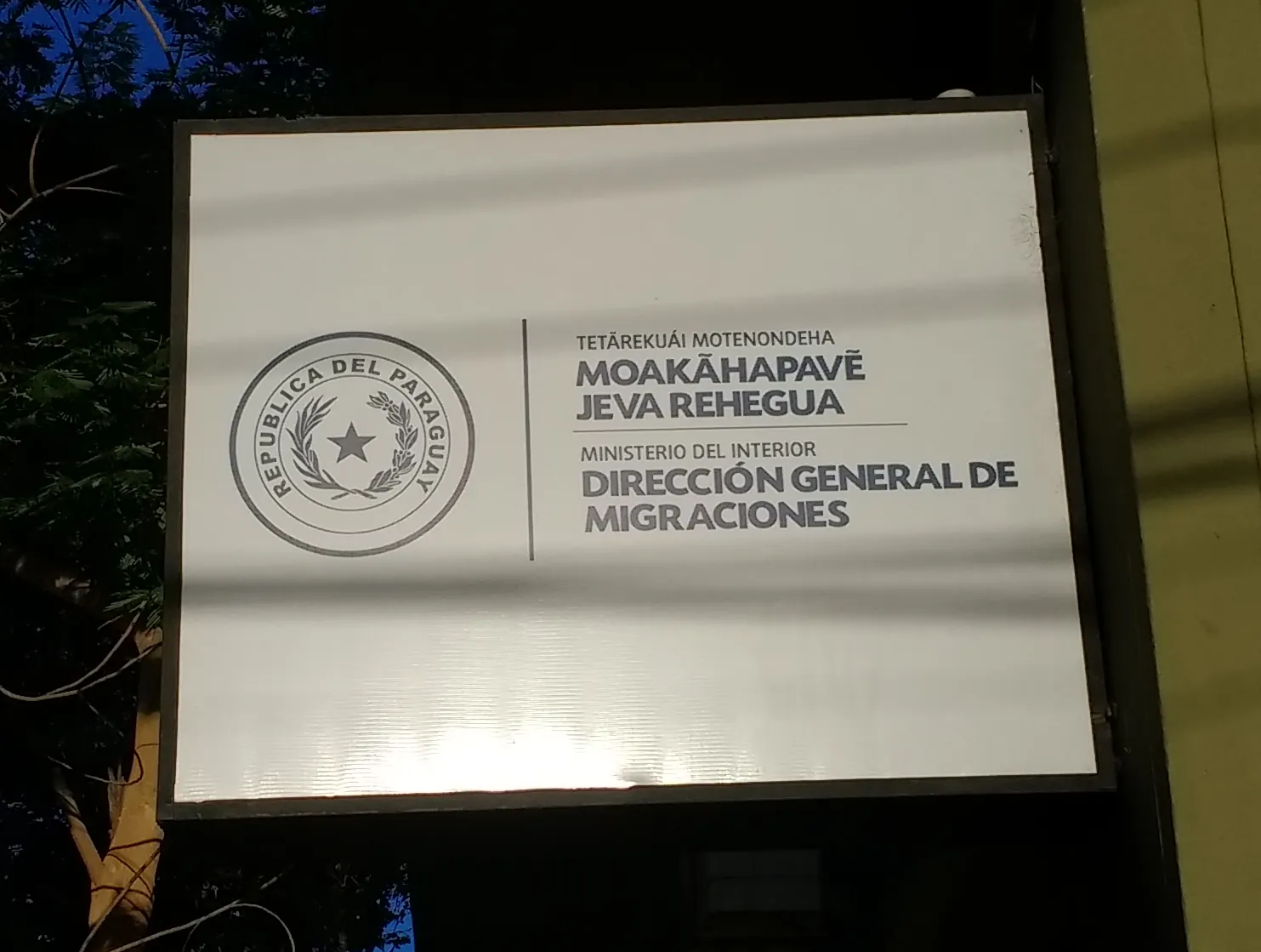 Cartel bilingüe en guaraní y castellano de la Dirección General de Migraciones de Paraguay en Asunción