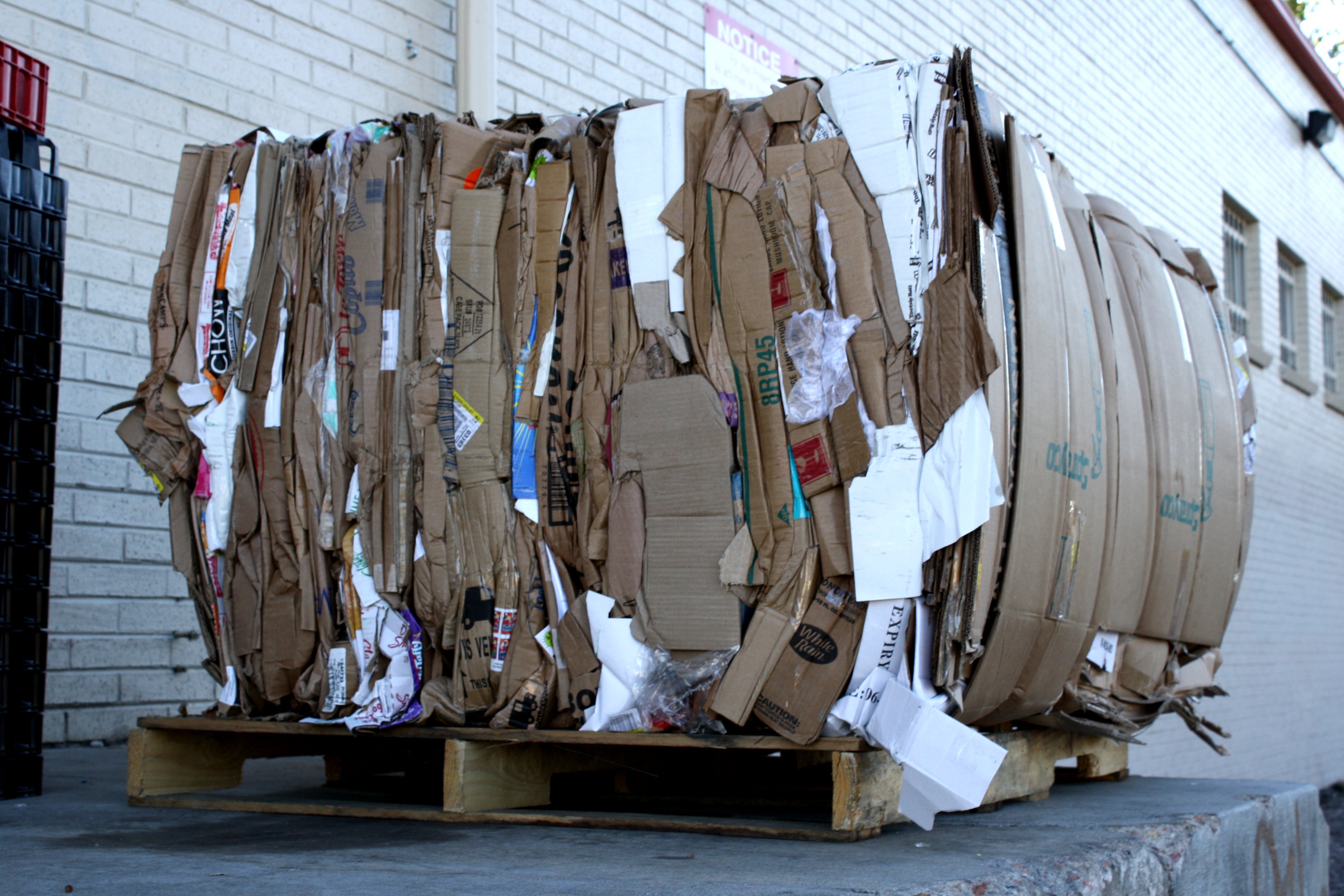 Bale of flattened cardboard on a wooden pallet
