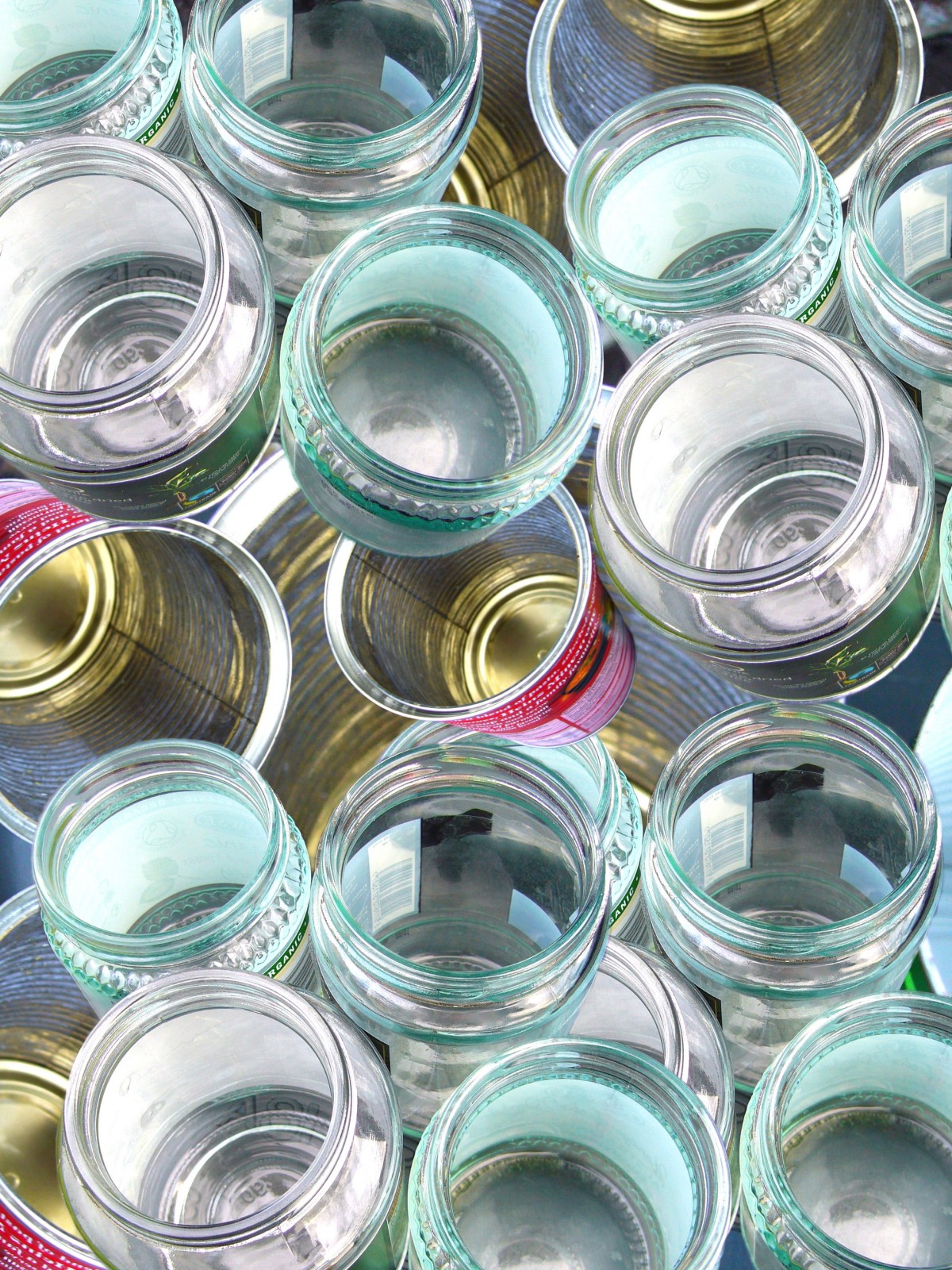 Empty glass jars and metal food cans viewed from above