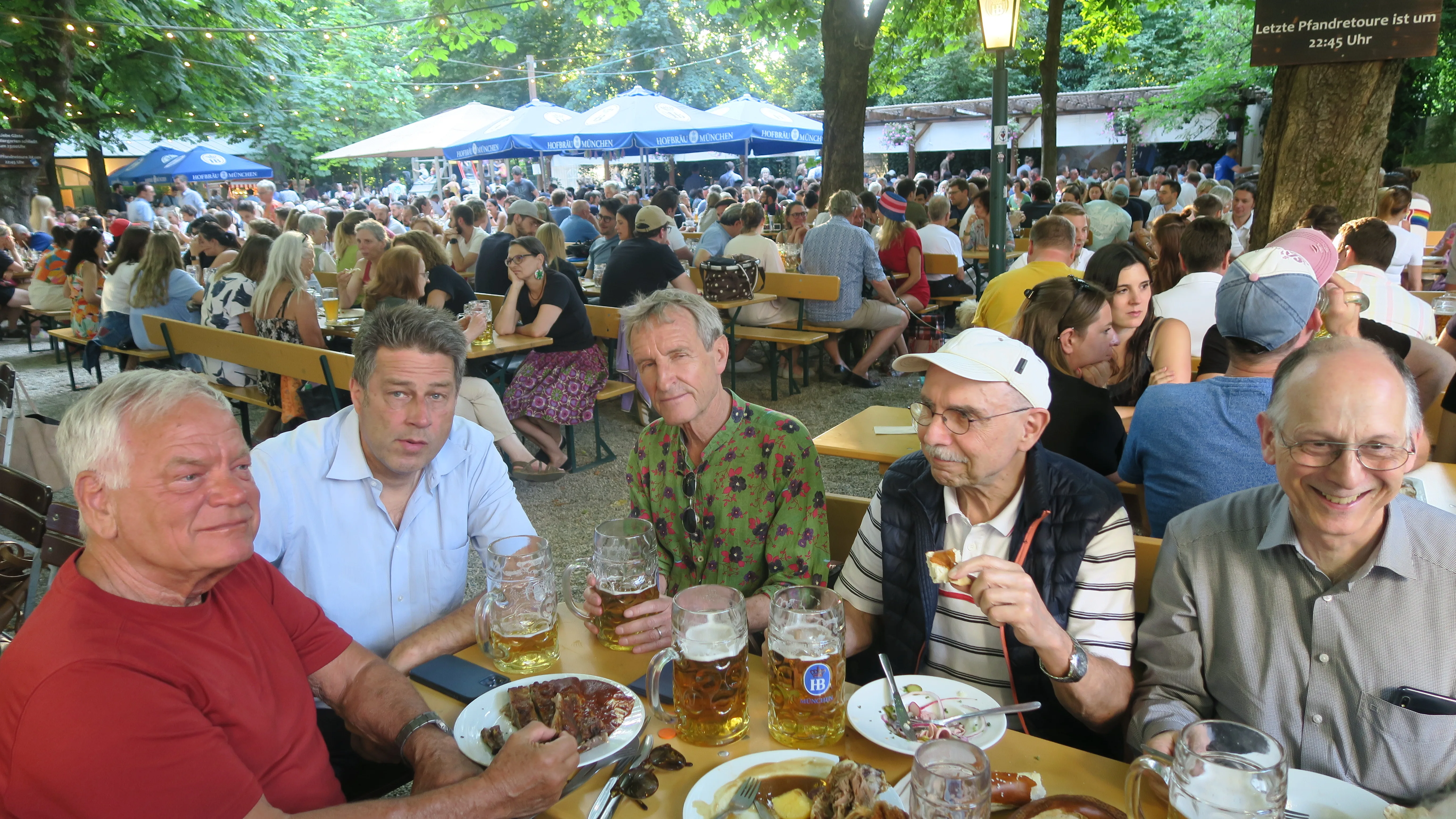 A group of people sitting around a long table at a weekly social meetup